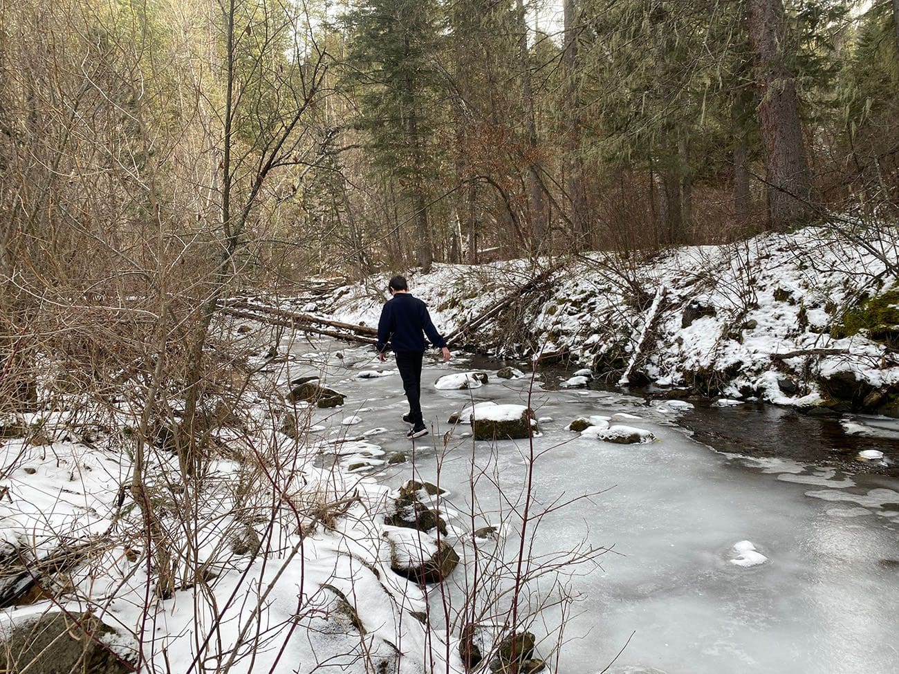 Walking on Cleopatra Creek covered in ice on Devil's Bathtub Trail
