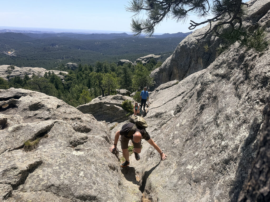 Group climbing rock scramble up Mount Baldy Trail near Keystone, SD