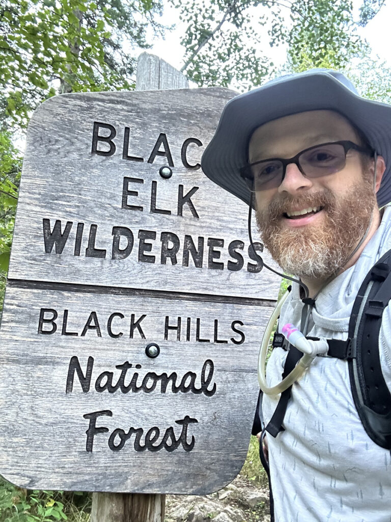 Logan S. at Black Elk Wilderness sign