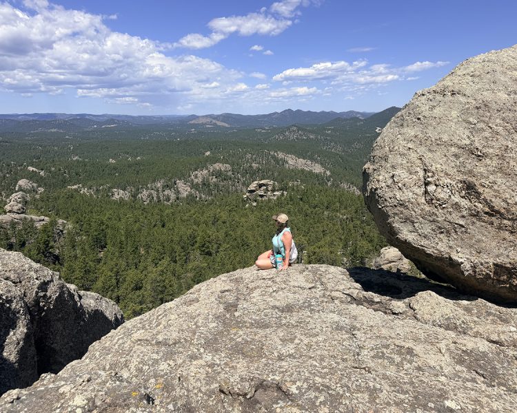 Woman enjoying the view at the top of Mount Baldy Trail near Keystone, SD